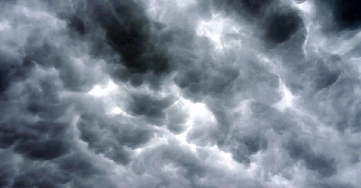 Majestic storm clouds fill the sky, creating a dramatic, moody atmosphere.
