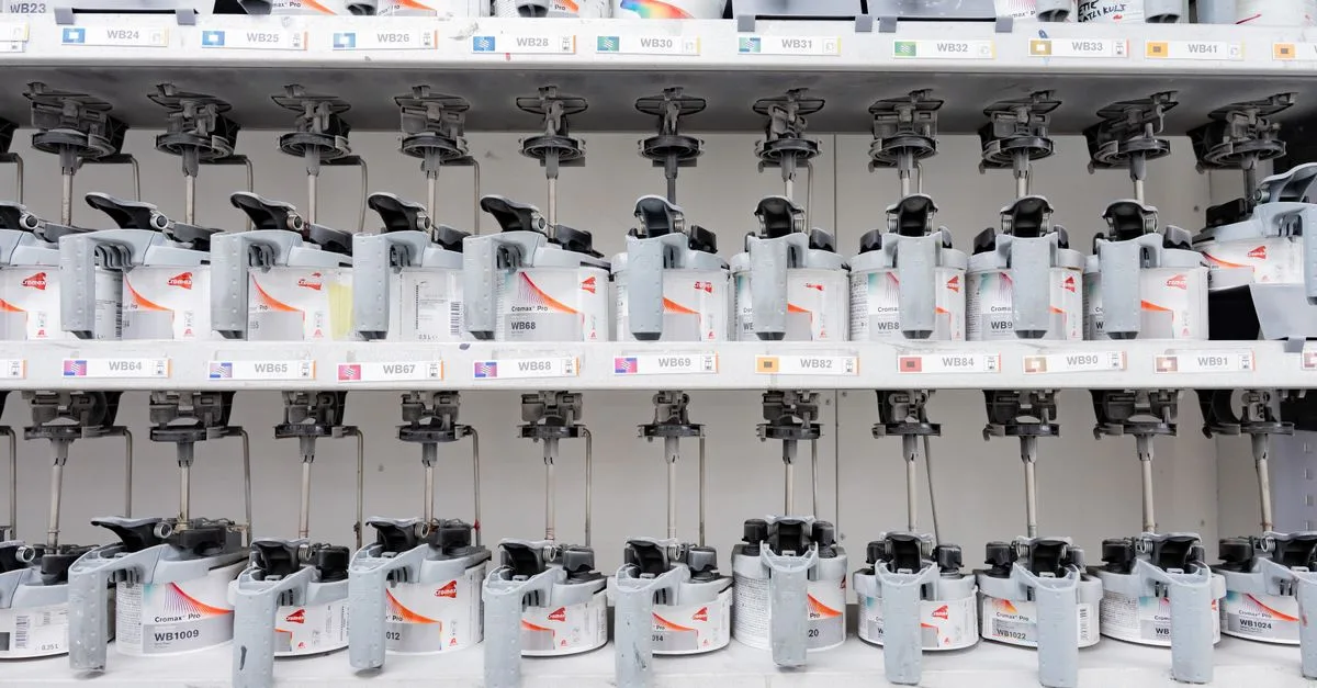 Organized industrial paint mixer station with multiple dispensers for accurate color mixing.