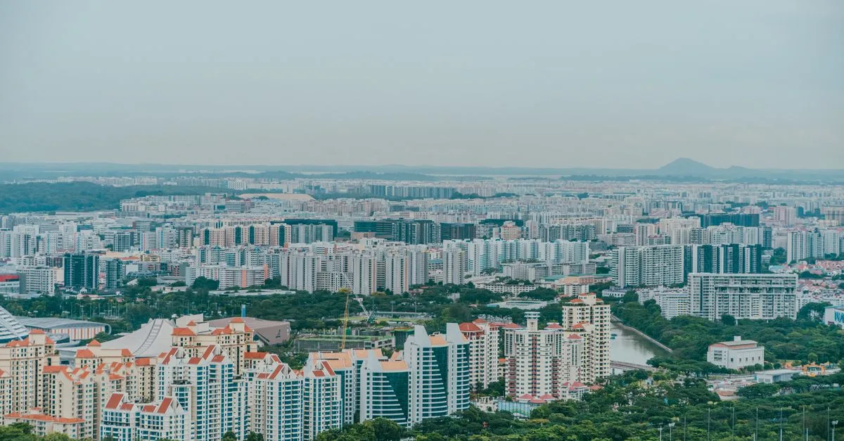 A panoramic aerial view showcasing the dense urban sprawl of Singapore's skyline with modern architecture.