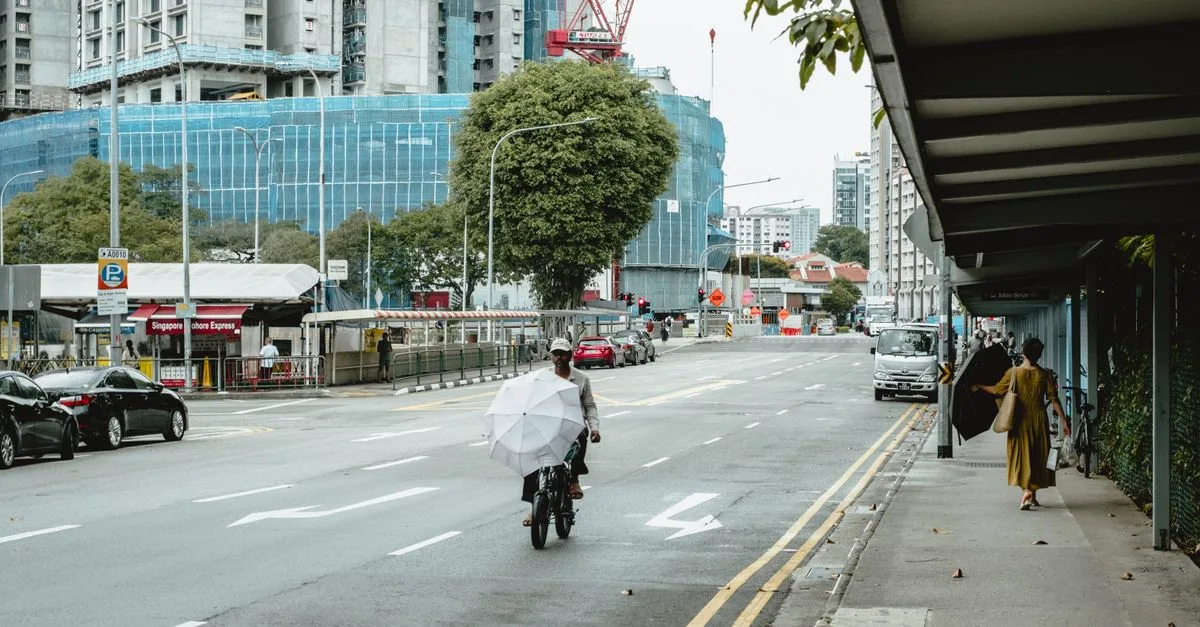 A bustling street scene with construction in Singapore featuring buildings and pedestrians.