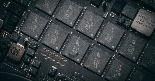 Detailed view of electronic circuit board components showcasing microchips and technology intricacies.