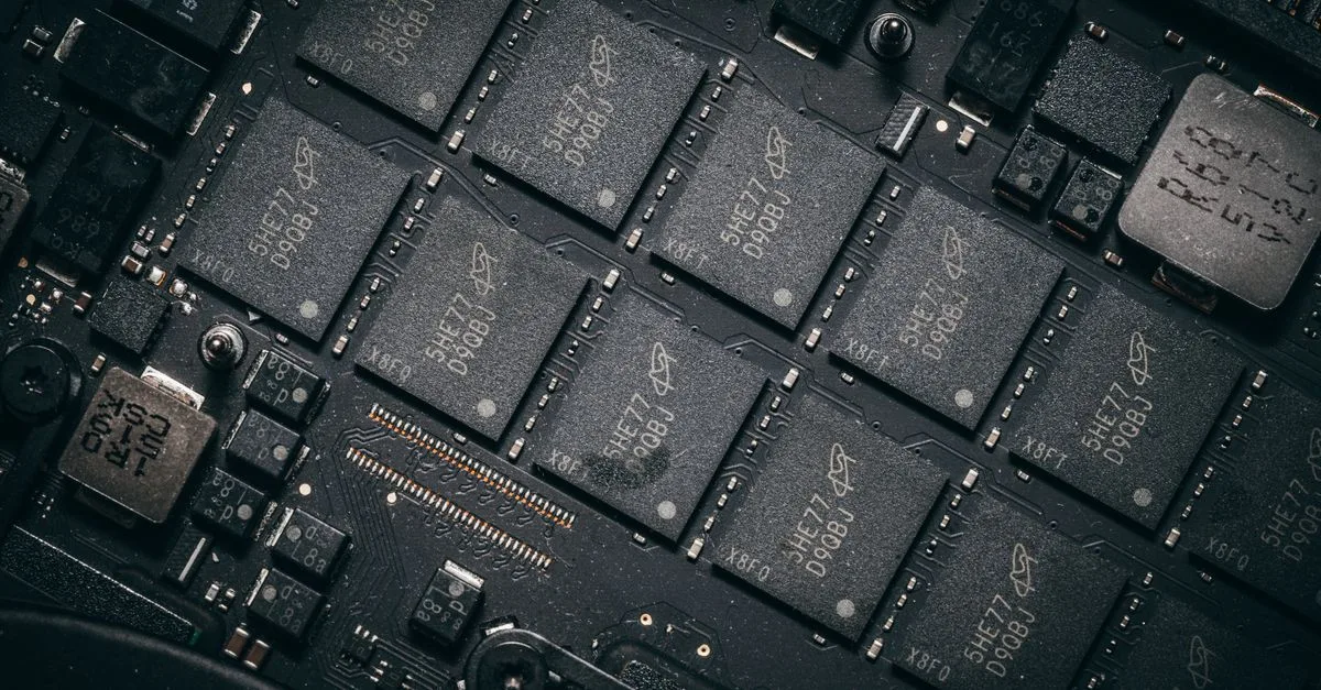 Detailed view of electronic circuit board components showcasing microchips and technology intricacies.