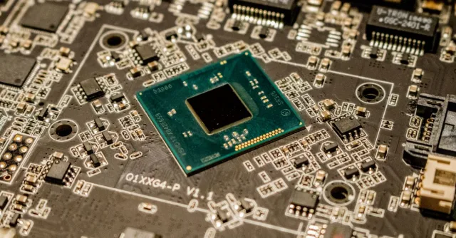 Detailed view of a microchip on a printed circuit board, showcasing electronic components.