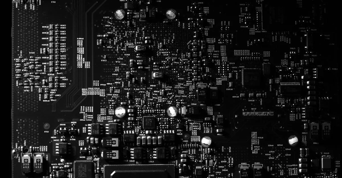 Detailed black and white photo of a circuit board showing intricate components, perfect for tech projects.