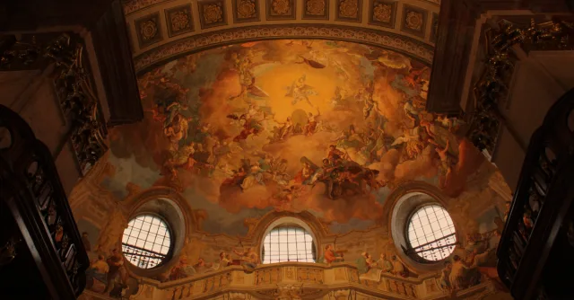 Captivating fresco ceiling artwork in a historic Vienna cathedral showcasing artistic brilliance.