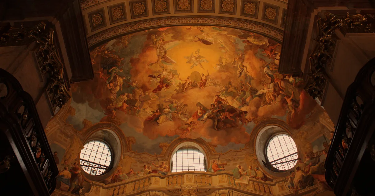 Captivating fresco ceiling artwork in a historic Vienna cathedral showcasing artistic brilliance.
