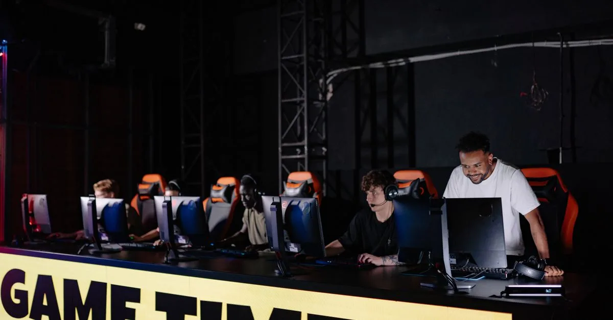 Esports team engaged in competitive gaming session indoors, showcasing teamwork and concentration.