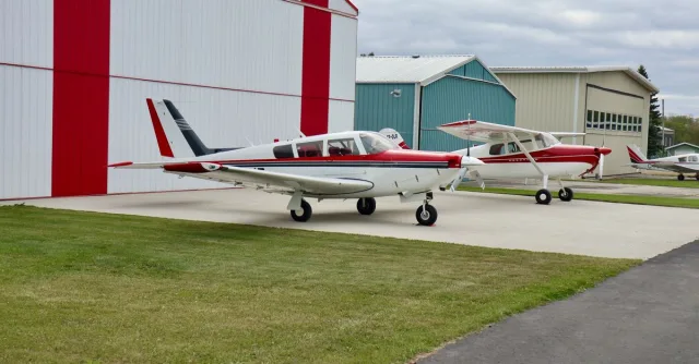 Private aircraft parked at an airstrip in Sherwood Park, Alberta, Canada on a cloudy day.