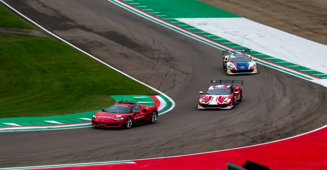 Exciting view of high-speed race cars navigating a professional racing track curve.