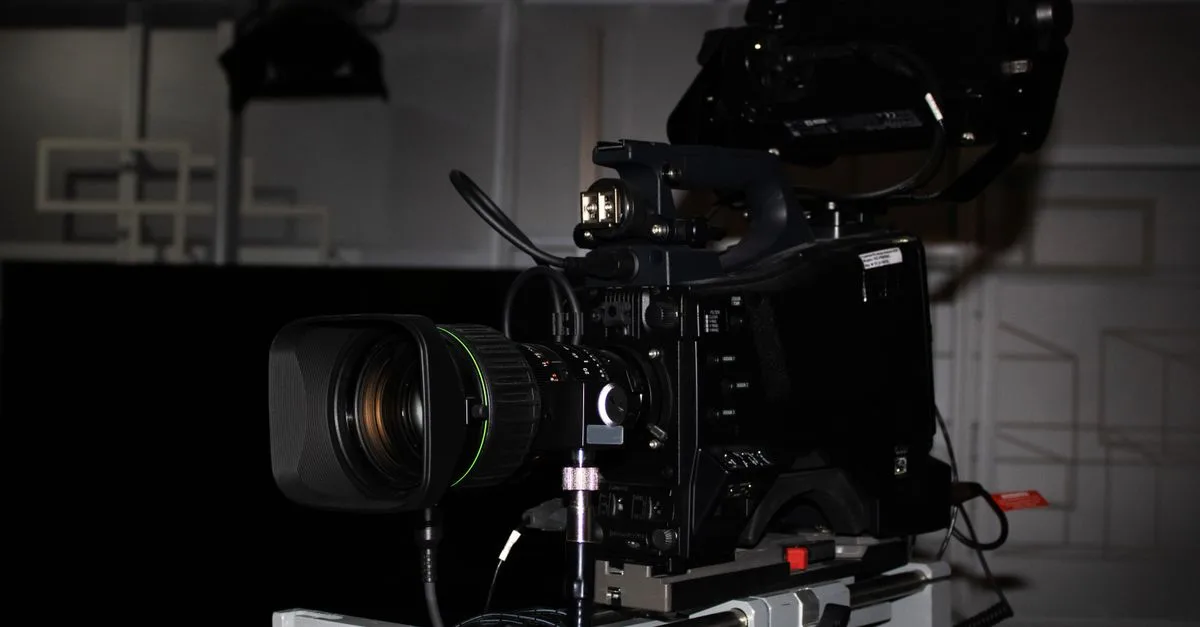 Close-up of a professional video camera rig in a studio environment, highlighting its complexity.
