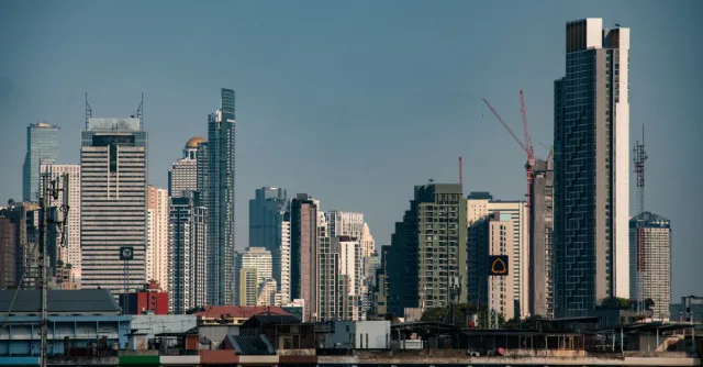 Stunning view of Bangkok's modern skyscrapers under a clear blue sky, perfect for travel inspiration.