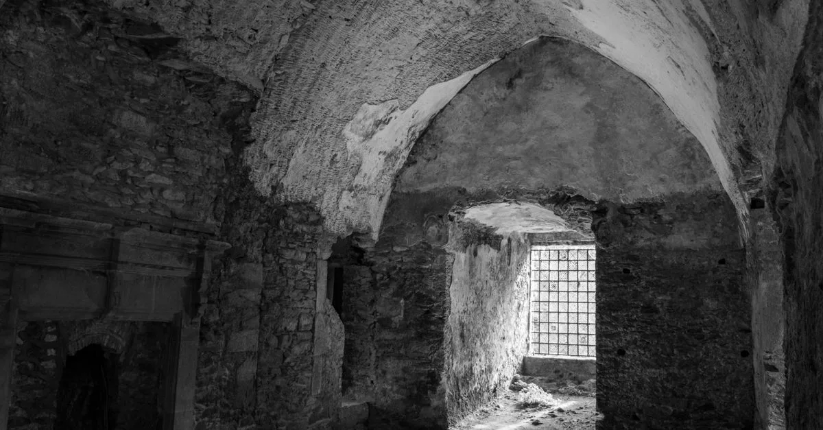 Black and white photo of ancient stone interior in Cork, Ireland.