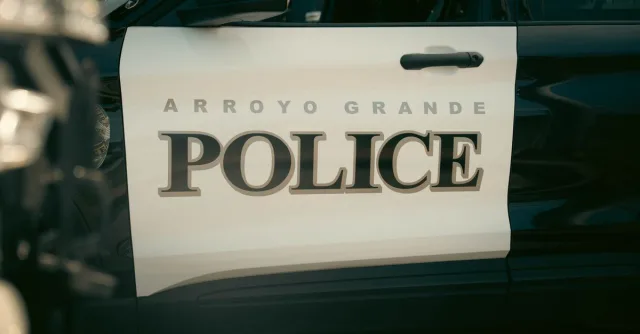 Close-up view of Arroyo Grande Police car door, showcasing bold text and design.