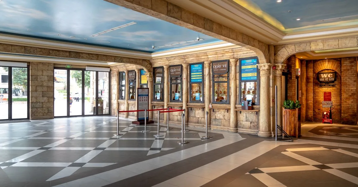 Spacious ticket booth area with elegant design and sky mural ceiling, perfect for luxury venues.