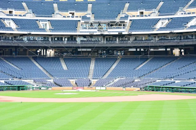 A wide view of a professional baseball stadium under bright stadium lights.