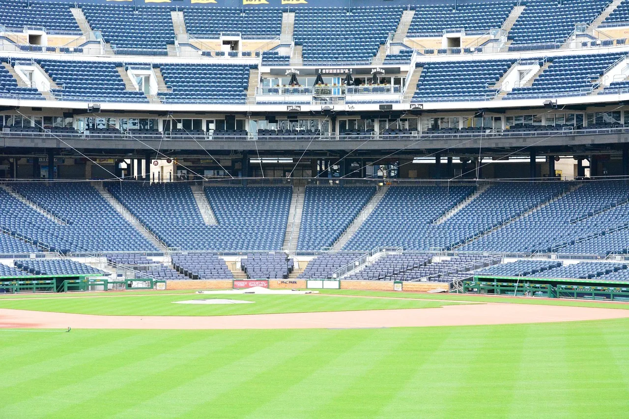 A wide view of a professional baseball stadium under bright stadium lights.