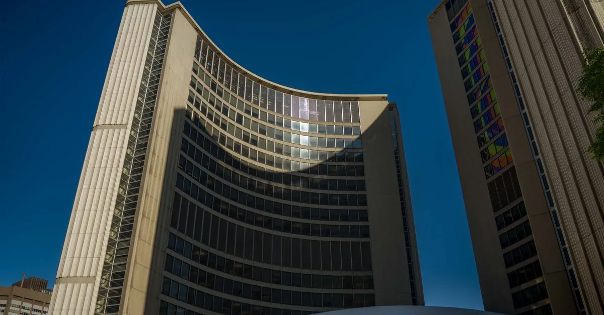 Stunning view of the curved facade of Toronto City Hall under a clear blue sky.