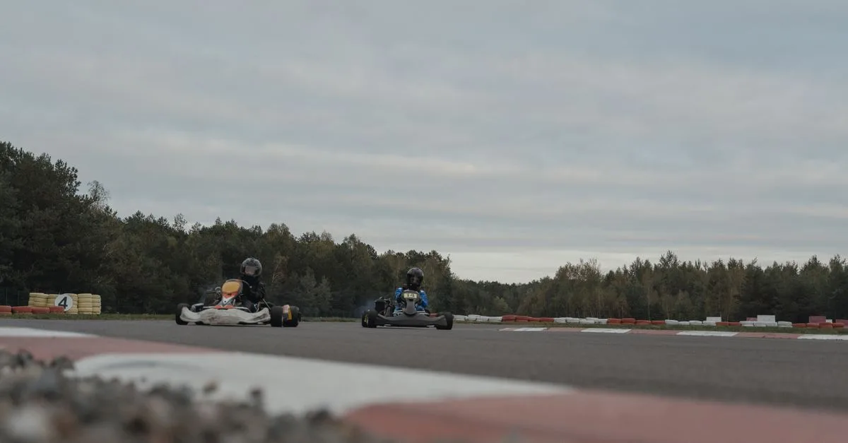 Thrilling karting competition as drivers race on an outdoor track amidst scenic surroundings.