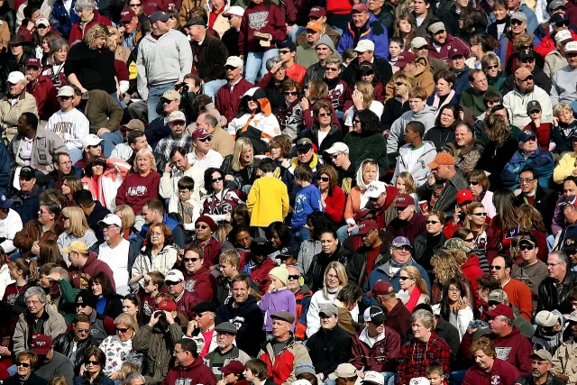 A wide view of a college football stadium filled with fans.