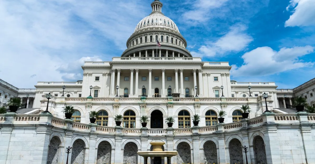 Exterior view of the iconic US Capitol Building on a sunny day in Washington, DC.