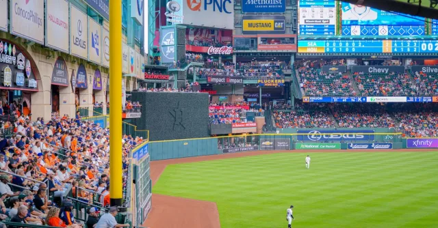 Vibrant baseball game scene with a full stadium, cheering crowd, and bright advertisements.