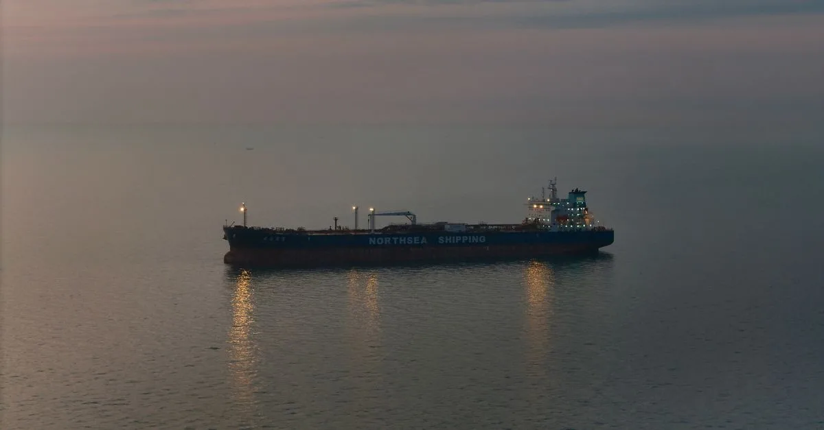Oil tanker 'Northsea Shipping' sailing on calm waters during twilight, reflecting a serene scene.