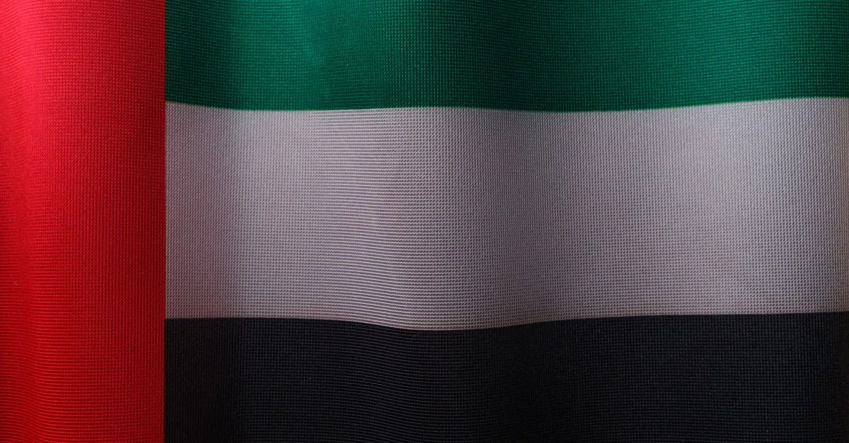 Detailed close-up of the United Arab Emirates flag with vibrant colors and fabric texture.