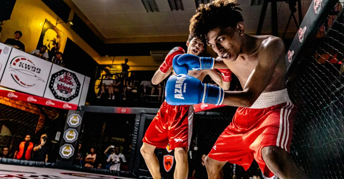 A dramatic MMA fight captured in George Town, Malaysia, showcasing action and athleticism.