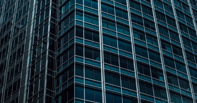 Detailed close-up of a modern skyscraper facade highlighting glass architecture.