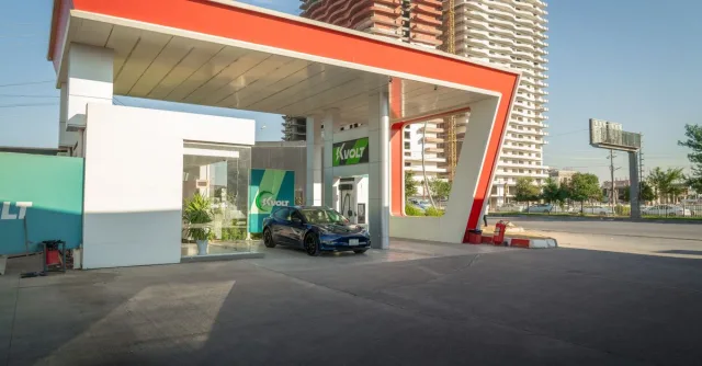 Electric vehicle at a modern charging station in an urban setting, promoting sustainability.