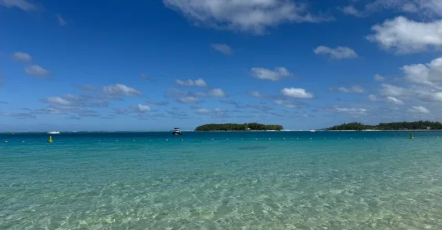 Crystal clear waters at Blue Bay, Grand Port District, Mauritius under a vibrant blue sky.