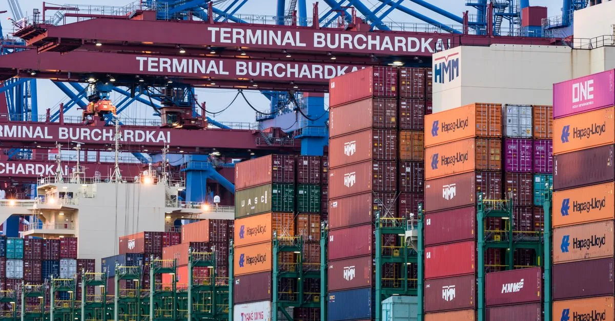 View of shipping containers and cranes at Hamburg's Burchardkai terminal.