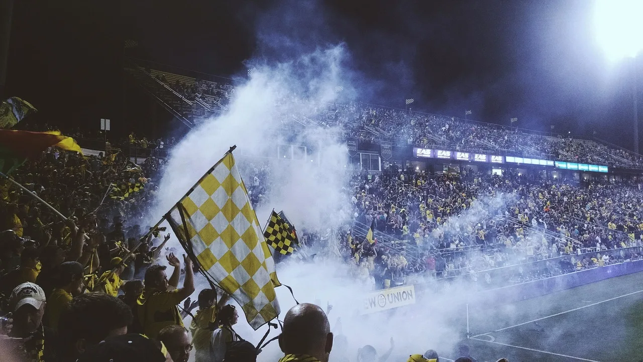 A professional soccer stadium illuminated at night.