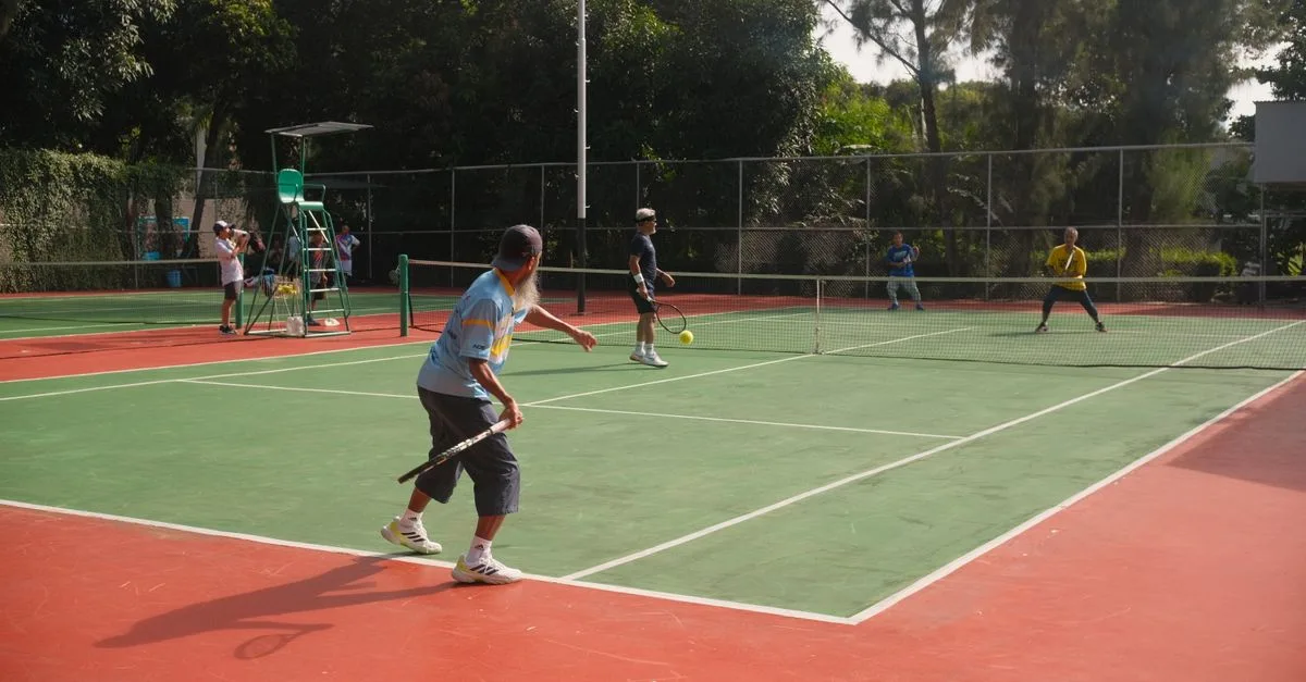 Tennis players competing on an outdoor court during a sunny day, enhancing sportsmanship.