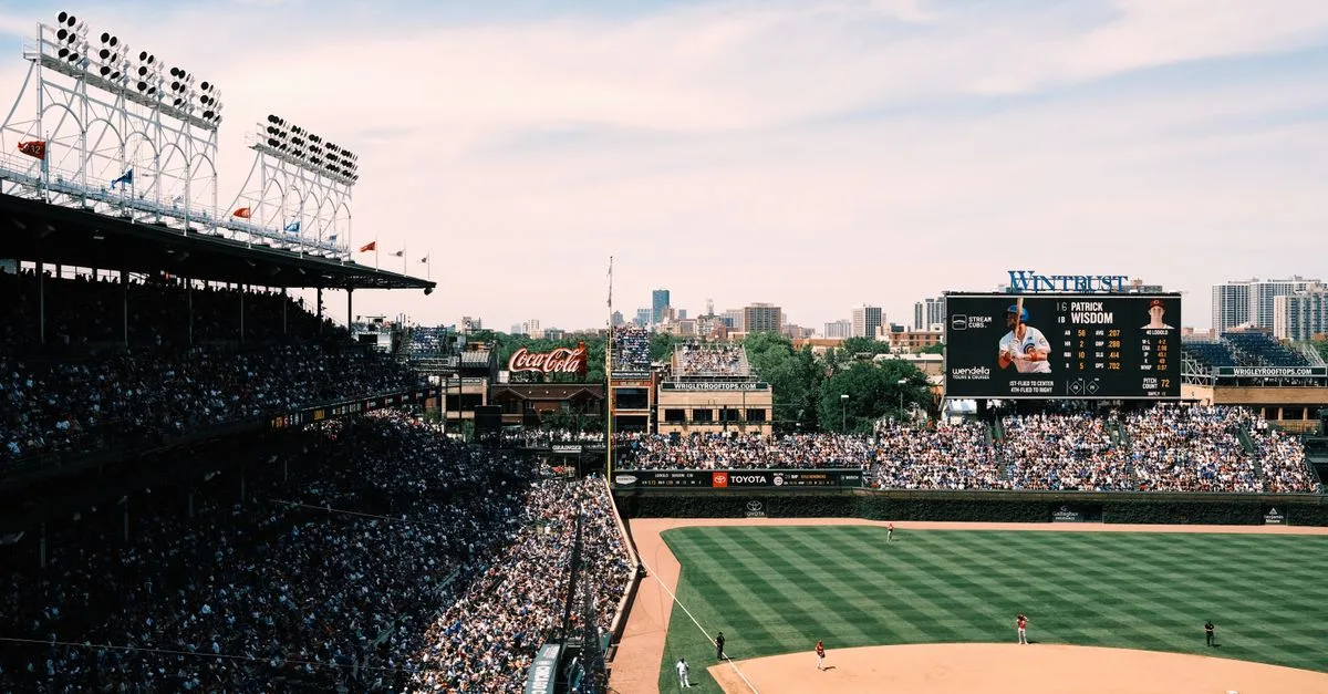 Aerial shot of a crowded baseball game at Wrigley Field, showcasing the vibrant cityscape of Chicago.