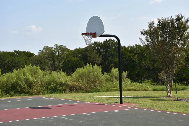 An empty professional basketball court with bright arena lighting.