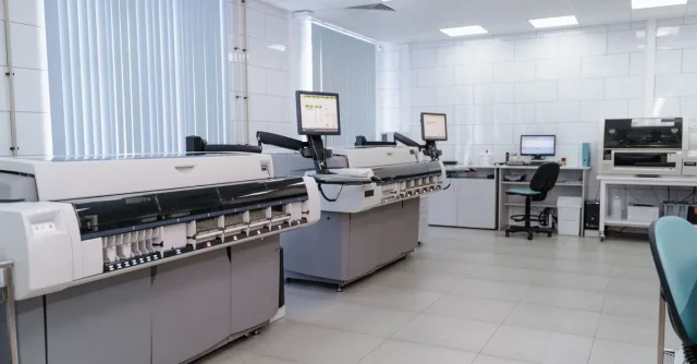 Spacious laboratory interior featuring state-of-the-art machines and computers for research purposes.