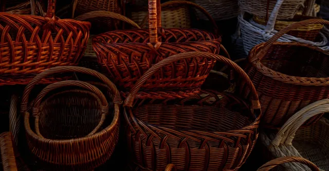 Close-up of various handcrafted wicker baskets, showcasing intricate woven designs.