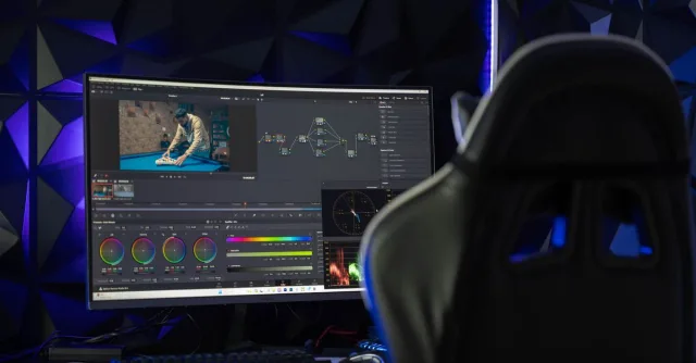 Curved monitor displaying video editing software in a tech-savvy workspace with mood lighting.