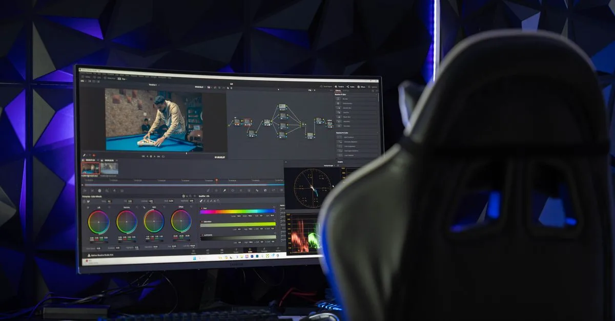 Curved monitor displaying video editing software in a tech-savvy workspace with mood lighting.