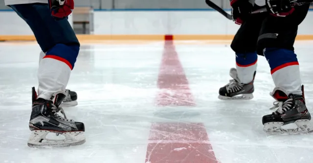 Players engage in thrilling ice hockey action on an indoor rink.